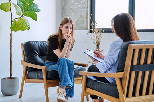 Young woman patient during therapy session in professional mental therapist's office - Powered by Adobe