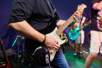 An Energetic and Enthralling Guitar Performance by Trendy Musicians on a Vibrant Stage