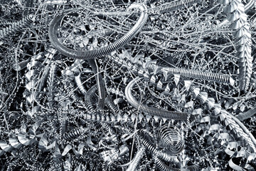 Metal shavings closeup texture. Sharp industrial spirals. Twisted steel curls background. Silver metallic waste from CNC machine. Mechanical scrap pattern. Perfect abstract background for engineering 