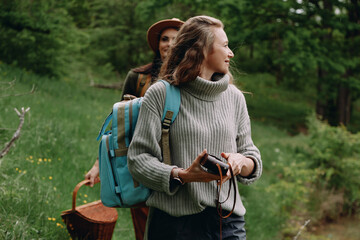 Active middle age woman enjoying nature hike outdoors with backpack, embracing healthy lifestyle...