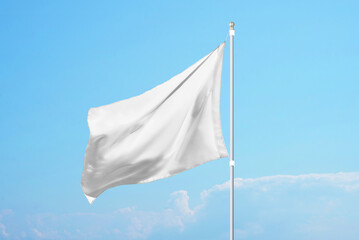 Empty white flag in the wind on clear blue sky, ideal for promotional design, customization or...