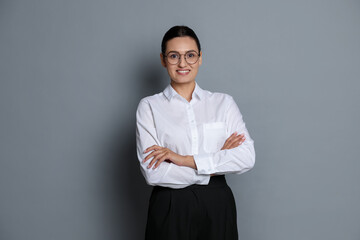 Portrait of confident business woman on grey background