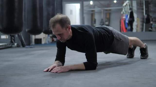 European man doing plank exercise in gym. sport. man standing on elbows in gym workout