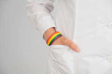 Close up of doctor's hand with rainbow bracelet. 
