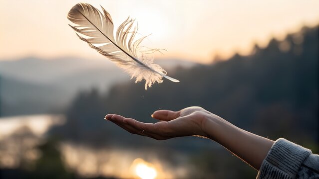 Hand letting go of a feather — it floats mid-air, paused