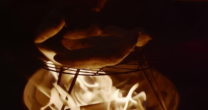 Traditional Fire-Roasted Sweet Potatoes on Open Flame