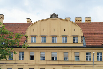 Historic building architecture with unique yellow facade in urban setting during daytime