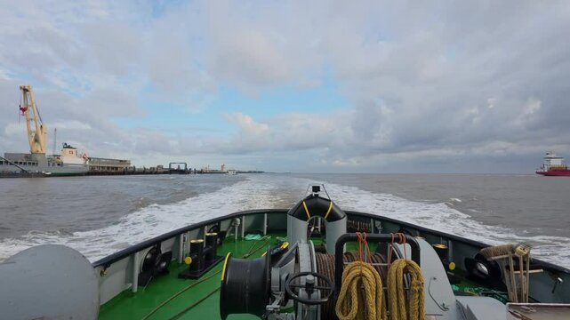 VSP tugboat proceeding along the Elbe river en route to a work site. Cuxhaven, Lower Saxony, Germany (4K 60fps)