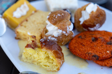 Sweet pastries and fruit display on white plate variety of desserts bufet in cruise ship