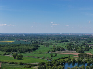 Breathtaking Aerial View Showcasing a Stunning Lush Green Landscape Against a Bright Blue Sky...