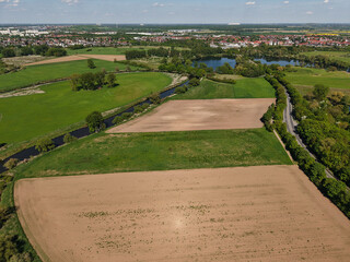 Aerial View of Serene Agricultural Landscapes, Lush Green Fields, and a Flowing River Koldinger...