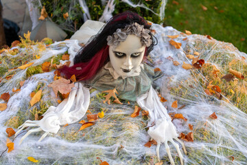 Celebrate All Hallows party holiday. All Hallows. October 31. Halloween zombie in autumn leaves....