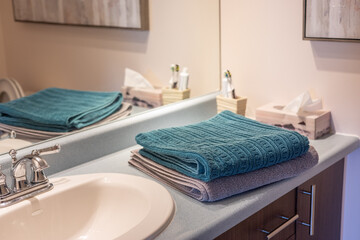 A neatly folded towel placed in a bathroom, ready for use and evoking cleanliness and comfort