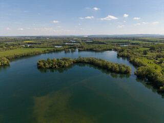 Enjoy a Stunning Scenic Aerial View of the Serene Lake Surrounded by Lush Greenery and Nature...