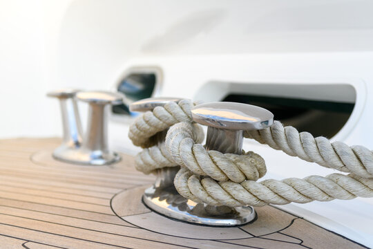 Bollard (cleat) with mooring line on superyacht. Mooring gear on yacht. Superyacht equipment. Side view.