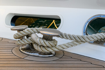 Bollard (cleat) with mooring line on superyacht. Mooring gear on yacht. Superyacht equipment. Side...
