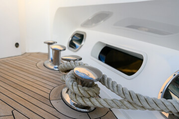 Bollard (cleat) with mooring line on superyacht. Mooring gear on yacht. Superyacht equipment. Side...
