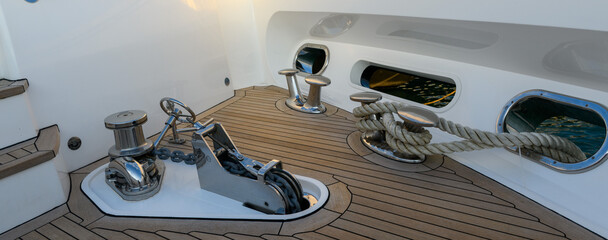 Anchor winch and cleat on superyacht. Anchoring and mooring gear on the bow of yacht. Superyacht equipment. 
