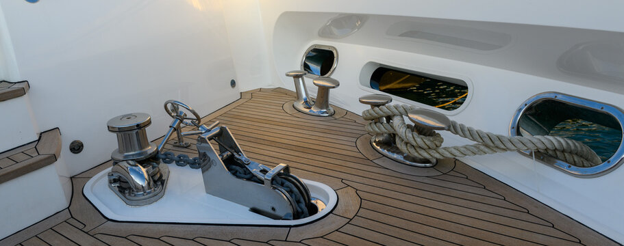 Anchor winch and cleat on superyacht. Anchoring and mooring gear on the bow of yacht. Superyacht equipment. 