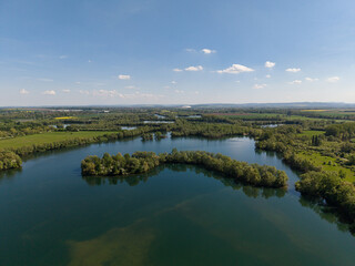 A breathtaking aerial view showcasing a serene river alongside a lush and vibrant green landscape Koldinger Seen Hannover Pattensen