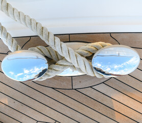 Bollard (cleat) with mooring line on superyacht. Mooring gear on yacht. Superyacht equipment. Side...
