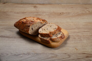 Artisan wheat light bread on wood background