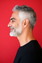 Obraz premium Conceptual art image of style for aging men. Trendy men's fade haircut - midlife middle eastern man with short hair. A trendy man showcasing a fashionable hairstyle. Red solid background.