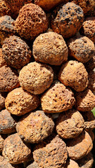 Ball-shaped volcanic stones are used as decorative materials to cover outdoor flower container...