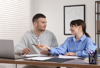 Fototapeta premium Consultant working with client at table in office. Business meeting