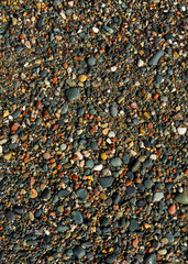 Closeup of natural pebble beach surface. Sea pebble beach. Texture of smooth sea stones. Ideal for...