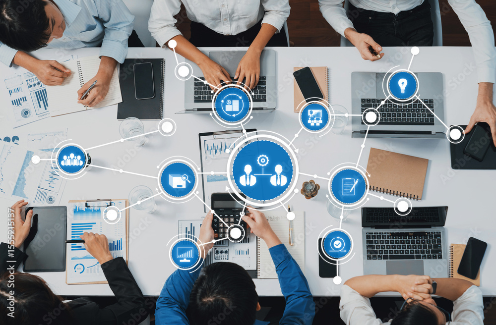Poster A dynamic team collaborates in a modern workspace, utilizing laptops and digital tools for data analysis. The scene illustrates teamwork and innovation in business settings. Amity