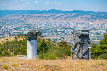 Columns of the Monument of the Chronicle of Georgia with a view of the city