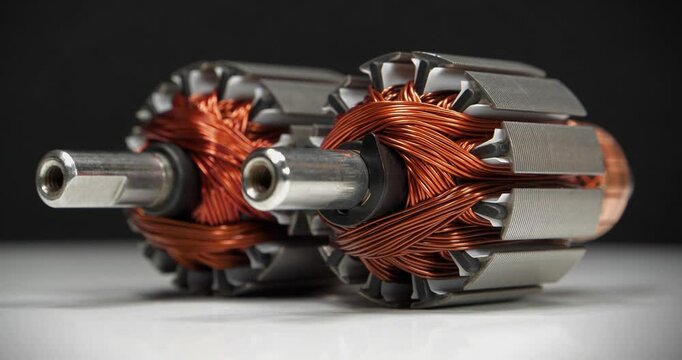 Two rotors with copper coil from electric motors from small household appliances, namely from percussion massagers. Cinema 4K 60fps zoom-out video