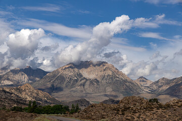 Summer cumulus clouds over the Sierra Nevada mountain range near Bishop, CA and the Owens Valley.