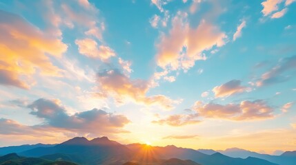 Obraz premium Panoramic sunset view over mountain range. Soft colors, hazy clouds