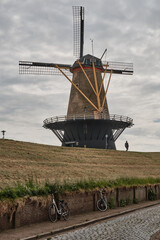Naklejka premium Historic windmill and sea dike along the Westerschelde in Vlissingen
