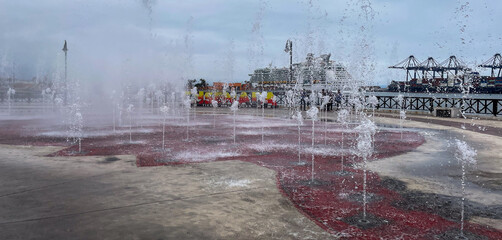 Ensenada, Mexico, June 5, 2025: The Public Fountain El Parque de la Bandera on the Waterfront Embarcadero in Ensenada with Music that is lit up at night.