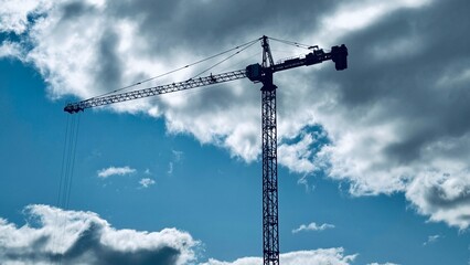 Tall cranes against clear blue sky ,Construction Projects Using Cranes Cranes above construction...
