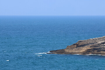 Cape on the coast. Rocky formation.
