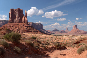 Majestic red rock formations and expansive skies over Monument Valley at midday