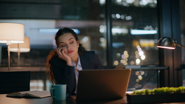 Overworked office woman rubbing eyes waiting finish work at evening room closeup
