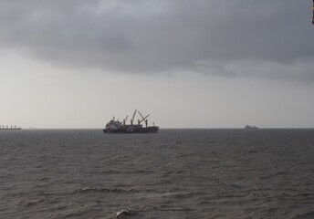 heavily overcast cloudy sky with choppy sea at chittagong anchorage, bangladesh