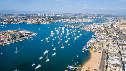 Scenic Aerial View of Newport Bay in Orange County, California – Coastal Harbor with Yachts, Waterfront Homes, and Blue Ocean Waters Under Clear Skies – Drone Photography of Newport Beach