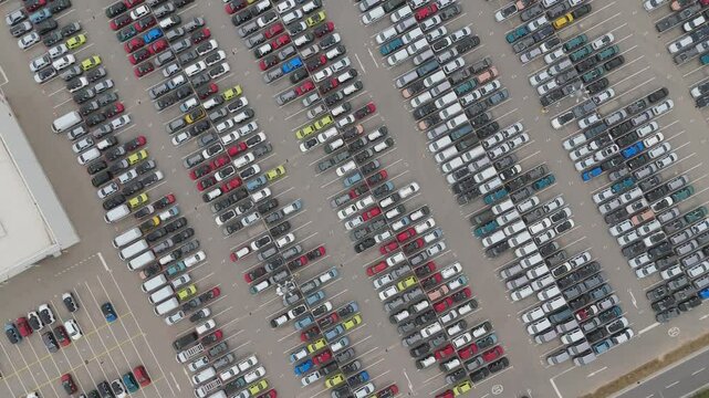 Top down drone video of newly manufactured cars parked at the factory in Trnava, slovakia
