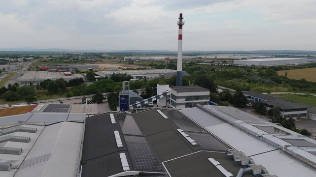 Modern furniture factory with solar panels and chimney from drone. Trnava, Slovakia