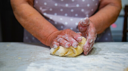 Granny baking buns in the kitchen. High quality photo