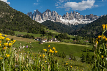 Scenic view of Santa Maddalena village with church and Geisler peaks in the Dolomites during spring.