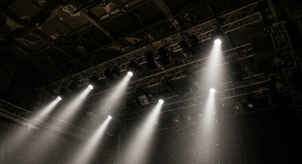 Bright Stage Lights Illuminating Dust Particles in Dark Venue