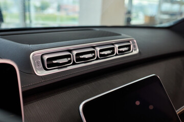 Closeup of car dashboard air vents near gear shift