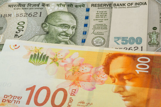 500 Indian rupee and 100 Israeli shekel banknotes. International trade concept